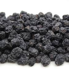 Close-up of plump, dark purple dries aronia berries
